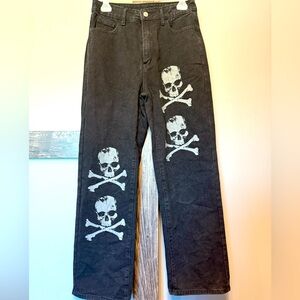 Women’s black, baggy jeans a with skulls.